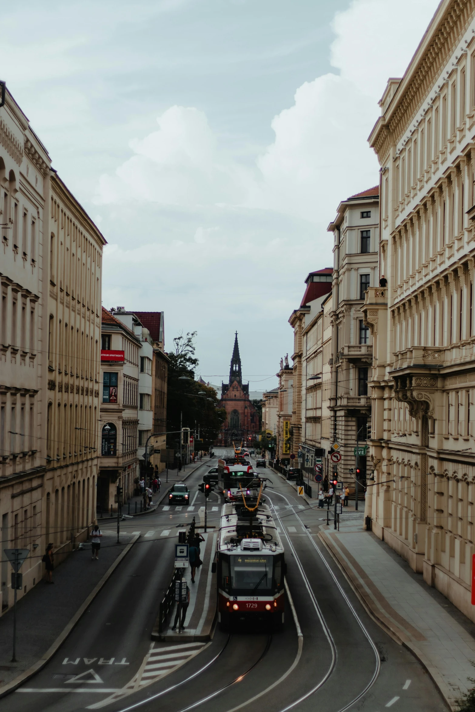 a narrow city street with many people on bikes