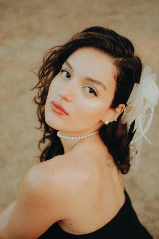 a close up image of a woman with a flower in her hair