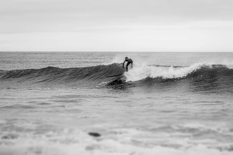 a surfer balances on his board as he rides a wave