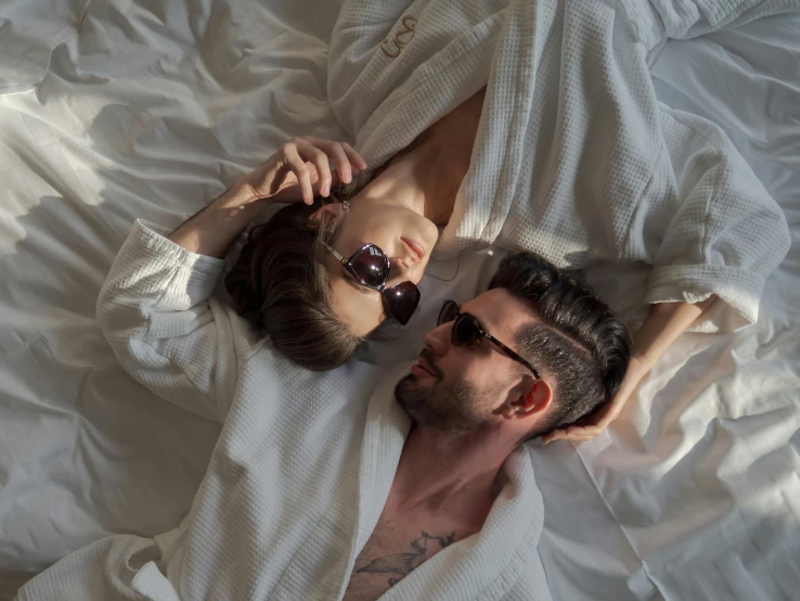 a man and woman are lying in bed