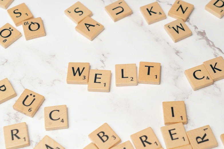 a white marble counter with wood tiles spelling out words