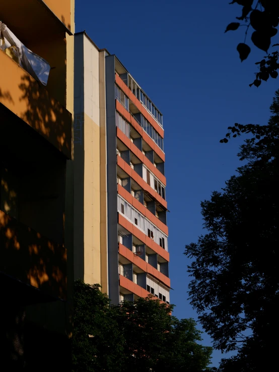 the corner of a building with several windows under a blue sky