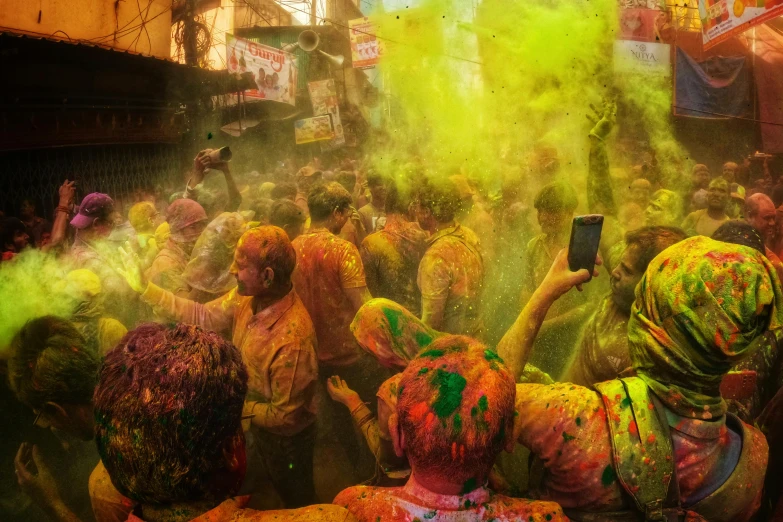 several people with different colored powder around their bodys