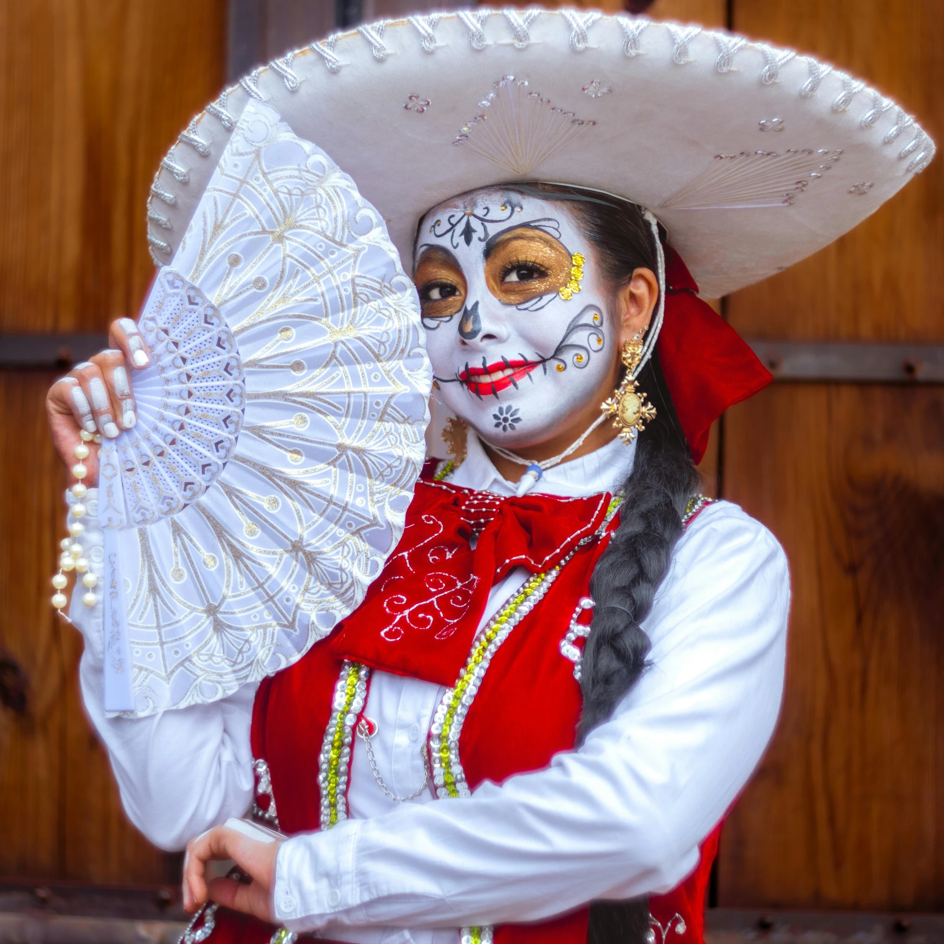 a woman in a mexican outfit holding an umbrella