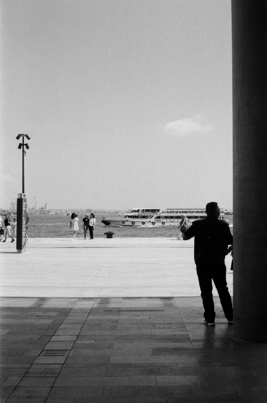 a man is looking at a clock tower