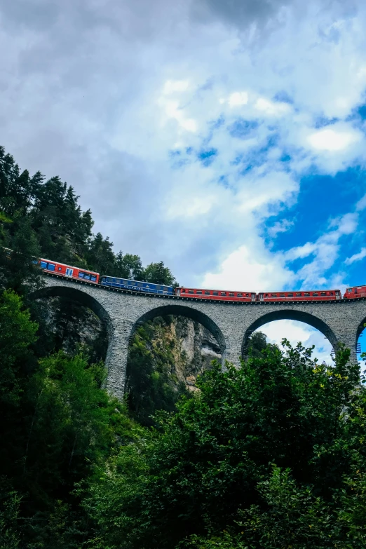 the train is traveling over the small bridge