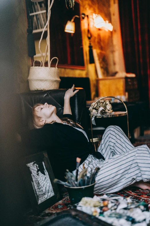 a woman laying on a leather couch in a room