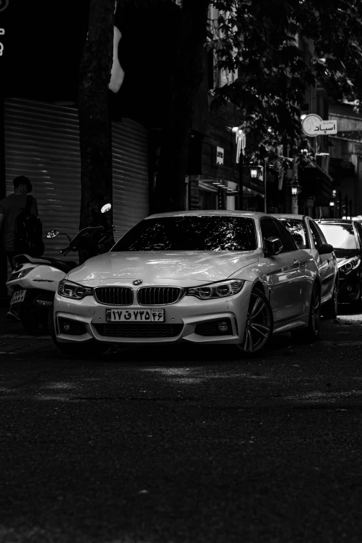 several cars parked along the side of a city road