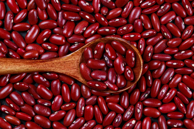 a wooden spoon full of red beans