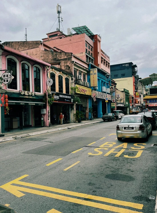 a street filled with tall buildings and parked cars