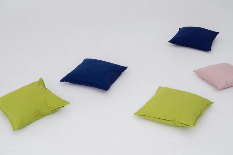 several different colored pillows arranged on top of each other