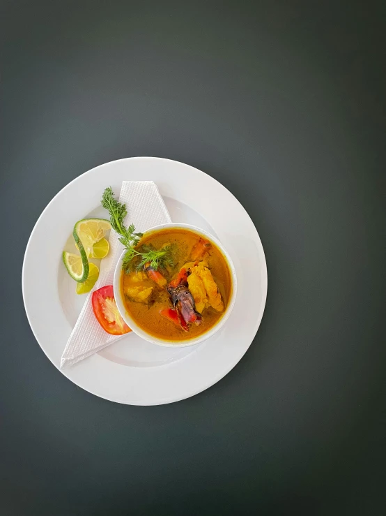 a bowl of soup, with an assortment of vegetables on top