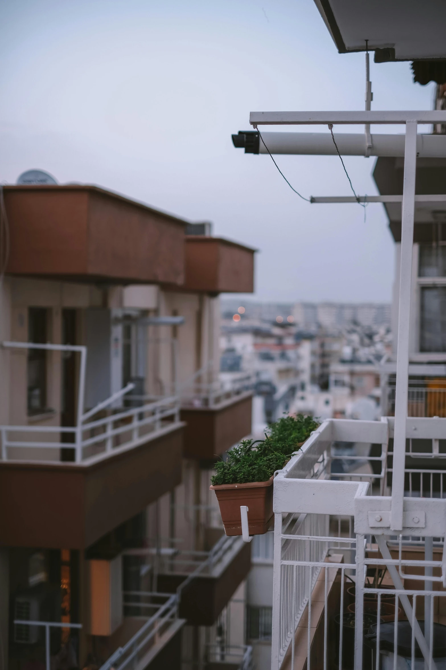 an outside balcony with planters, balconies and windows