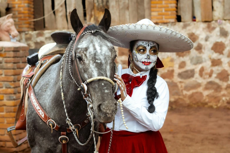 a woman dressed up like a mexican girl with horse and makeup