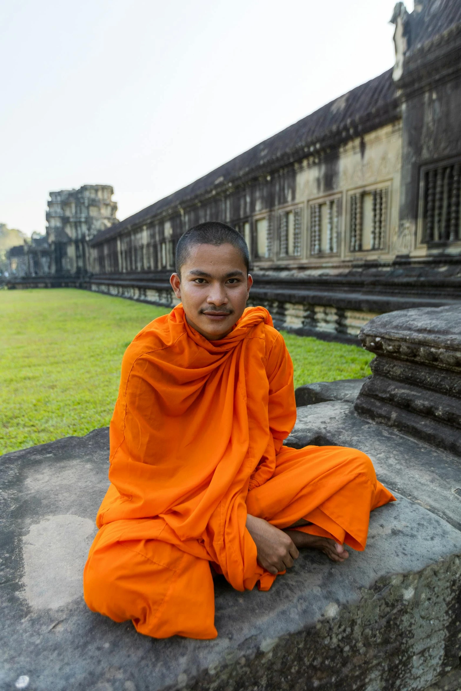 the monk is sitting on steps in the temple