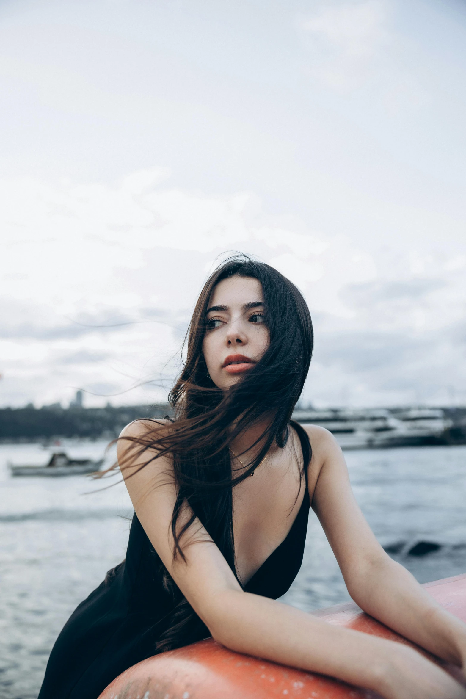 a woman sits on a surf board and looks at the camera