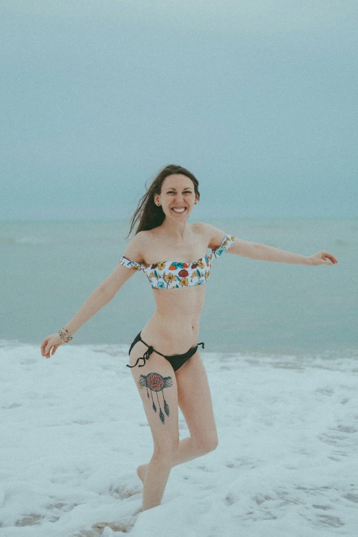 a young lady wearing a bikini at the beach