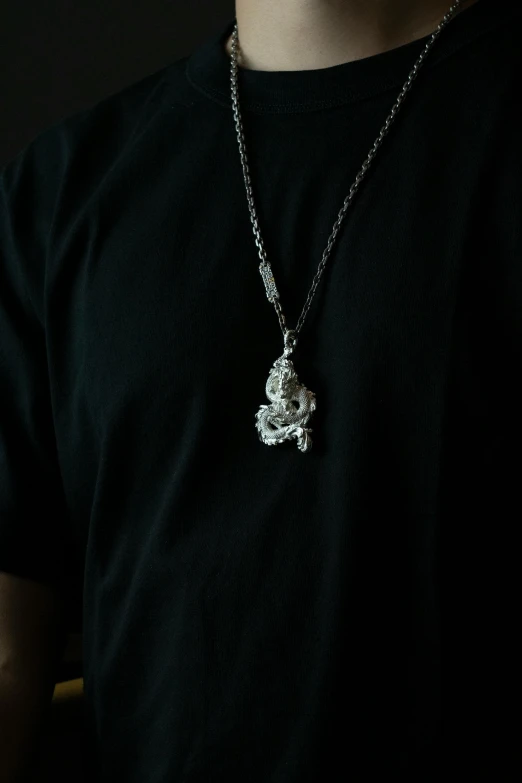 the shirt of a man with a black shirt and a chain