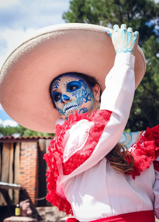 an person with face painted in red and white