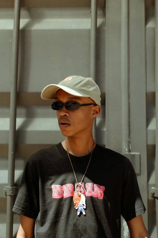 a man in black and white baseball cap and sunglasses