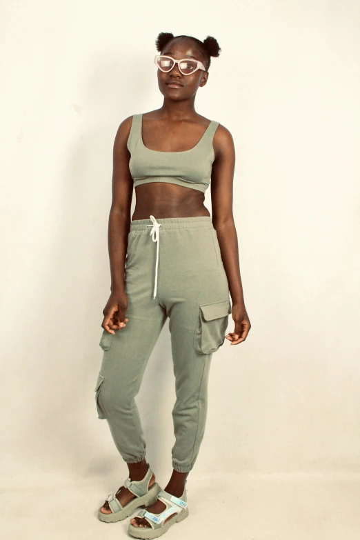 a woman wearing a  with crop tops and sweat pants