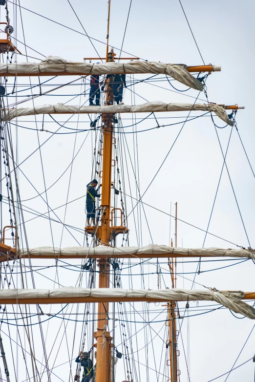 some people standing on the sides of tall wooden structures