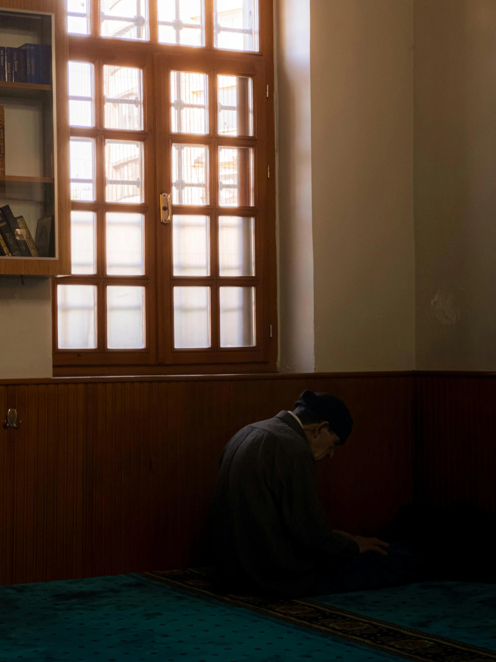 a man sits on the floor and looks at his laptop