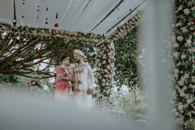 the bride and groom are standing underneath the chute