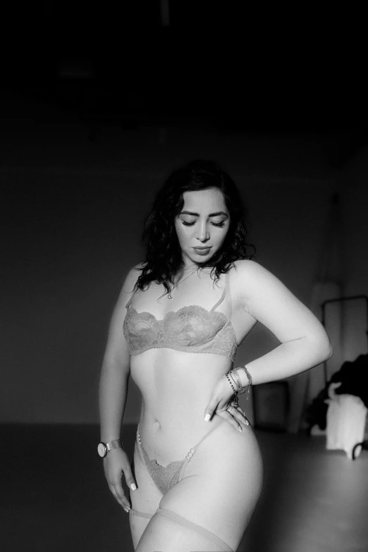 a black and white pograph of a woman wearing lingerie