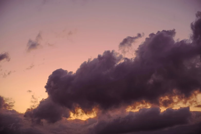 clouds roll into the sky as the sun rises