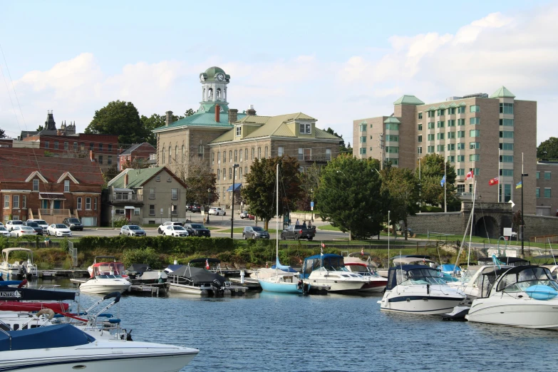 boats are tied up to a dock in a city