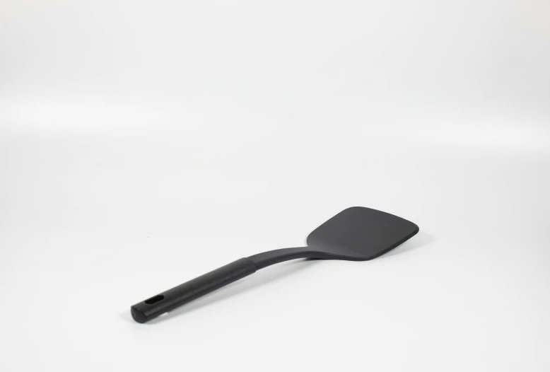 black spatula over white background for use in cooking