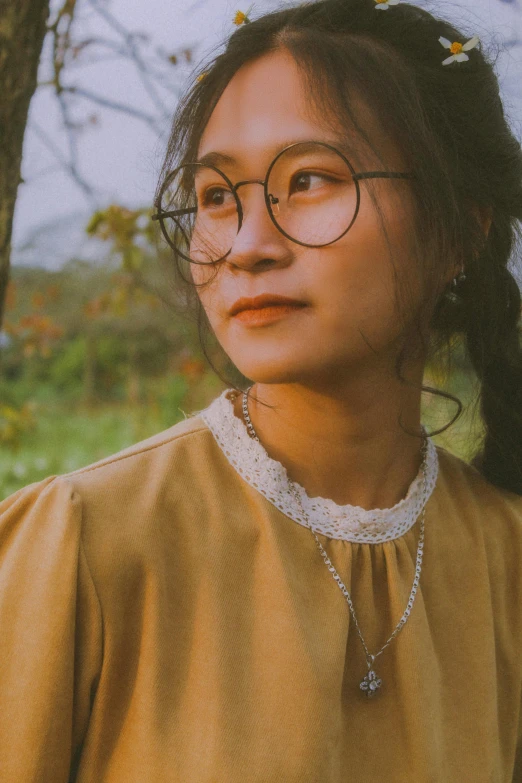 a young lady in glasses poses for the camera