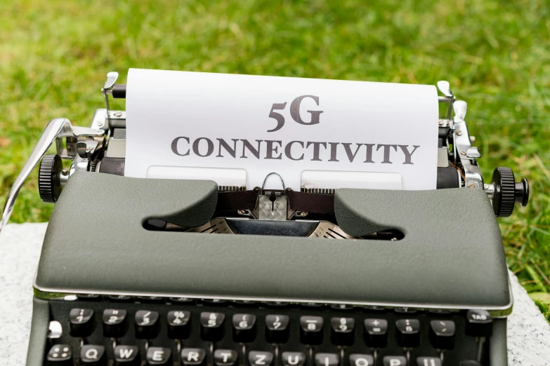 the text 5g connecitivity is on top of the black typewriter