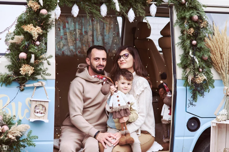 a man and woman with a child pose for a family portrait