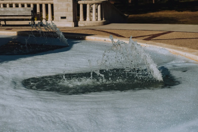 a sprinkle is shooting at a water fountain