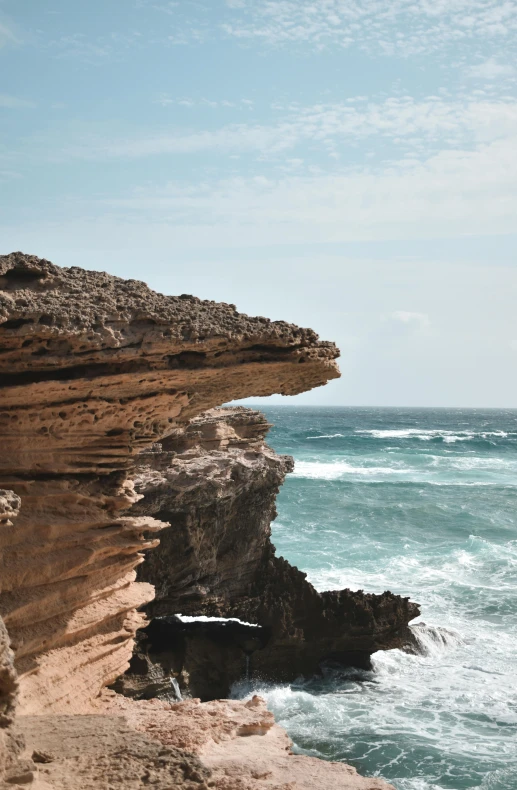 the rocky coast is lined with a large formation of layers