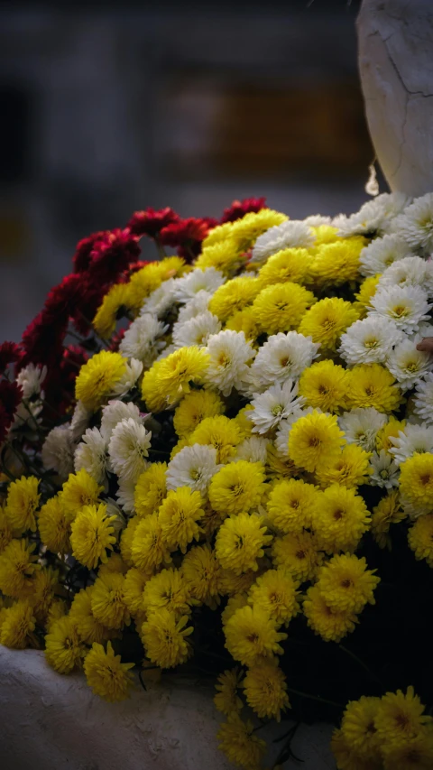 the bouquet of flowers is all white and yellow