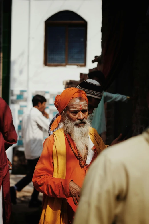 a man in orange is standing with other people