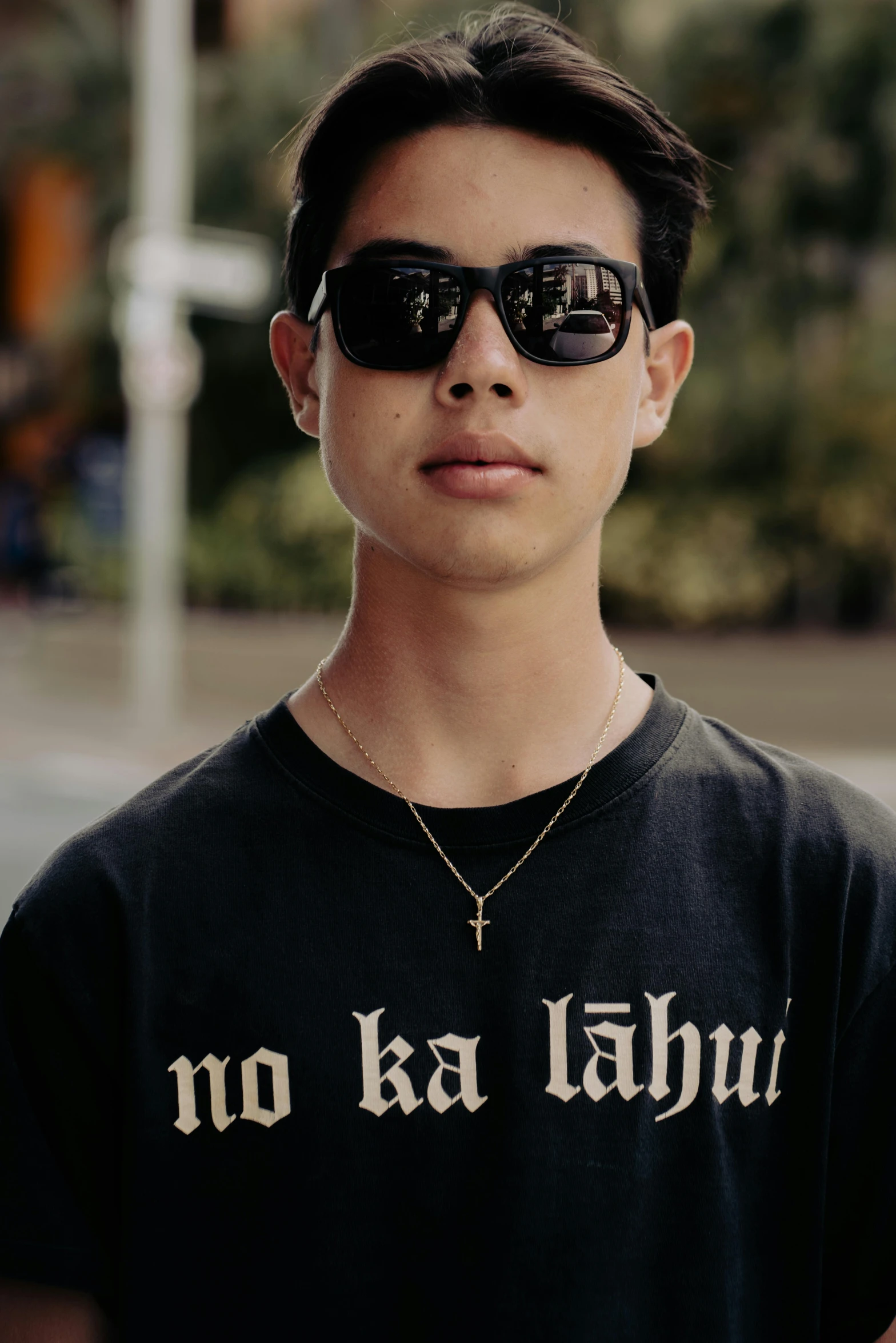 a man wearing sunglasses standing in front of the camera