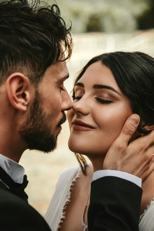 an image of the bride and groom kissing each other