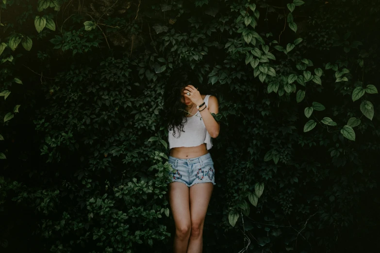 a young woman in short shorts and white shirt with headphones