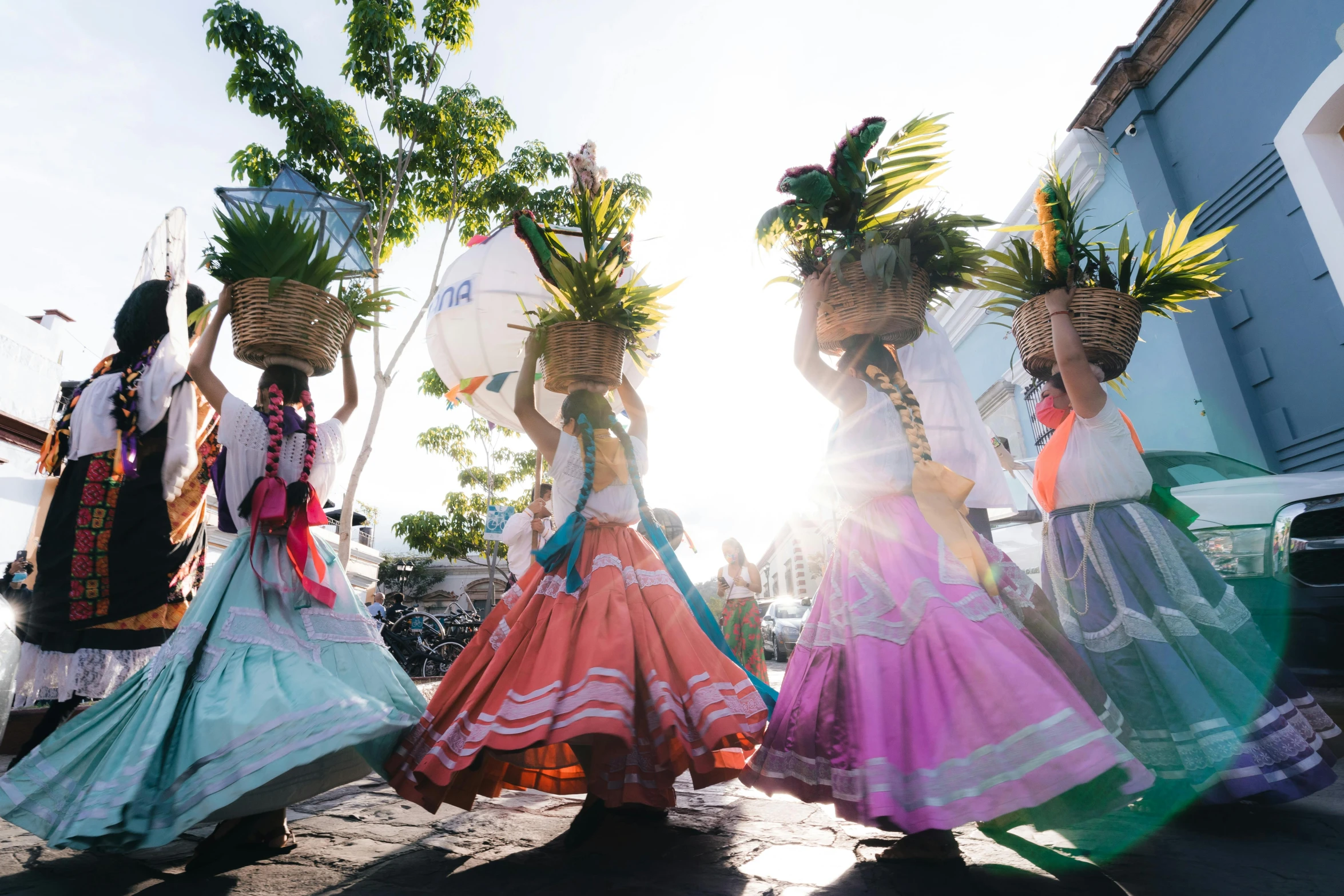 a group of young women dancing in front of a building