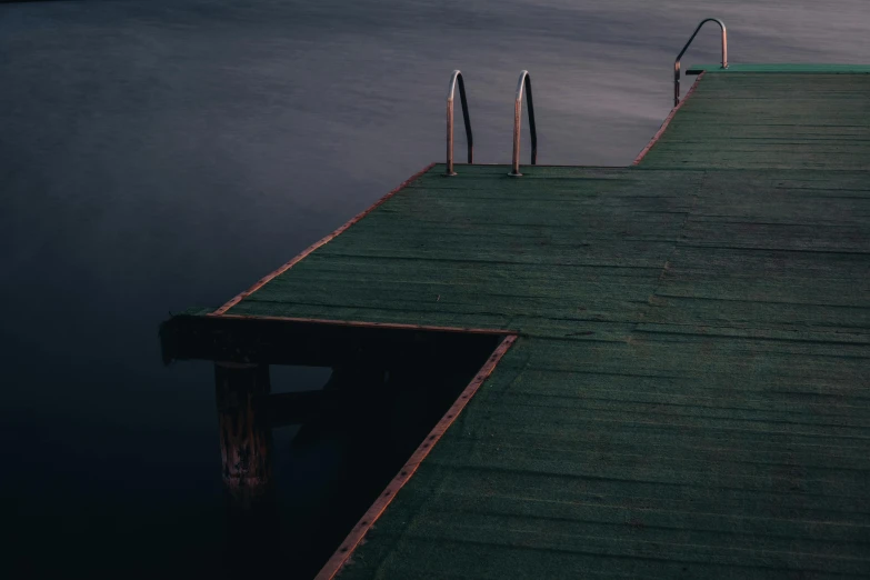 a boat dock sits empty on a calm lake