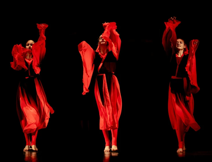 two models walk and pose in red fabric