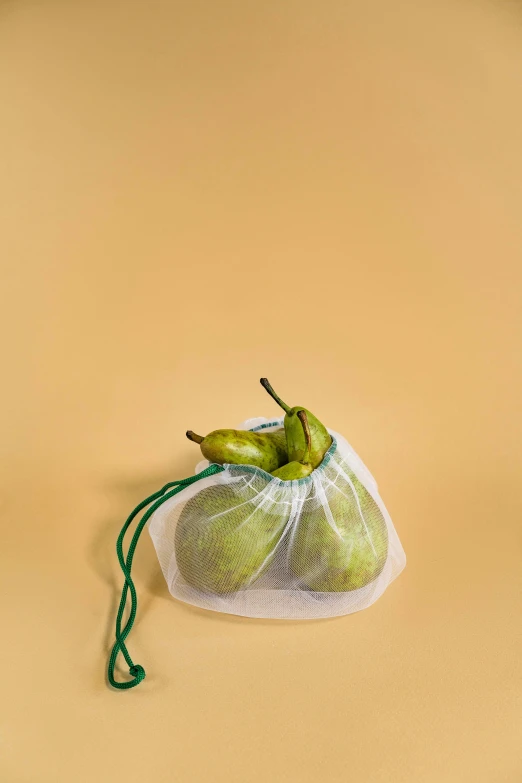 two bananas sitting on a cloth drawstring bag