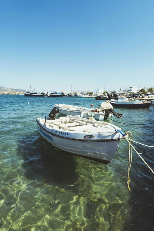 four boats that are sitting on the ocean