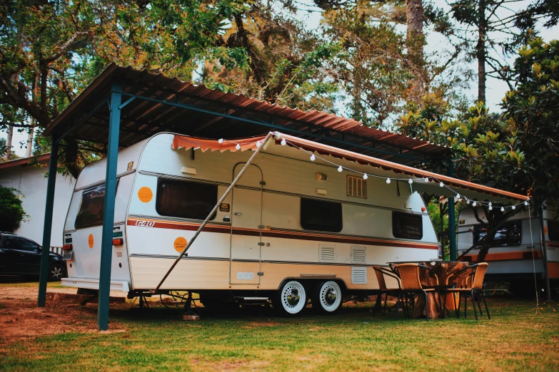 a recreational vehicle that is parked under a carport