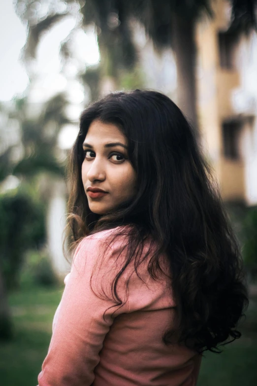 a woman with long hair looking at the camera