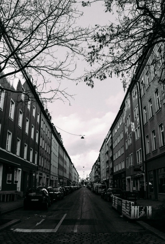 an empty street lined with tall brick buildings